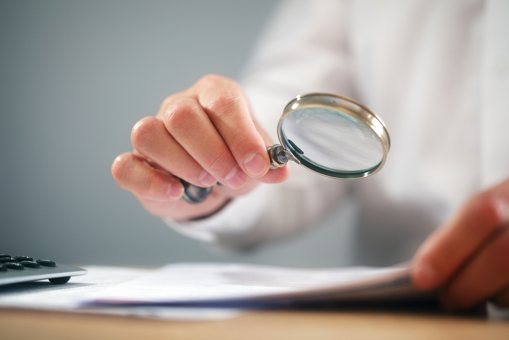 Using magnifying glass to read small print
