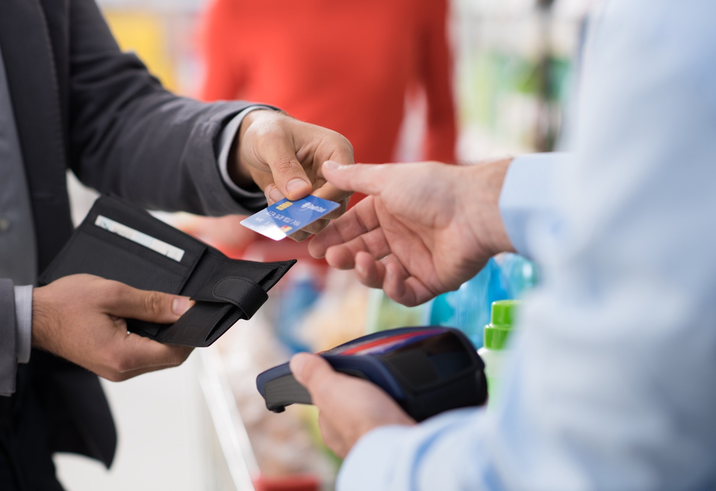 Boss handing over credit card to employee