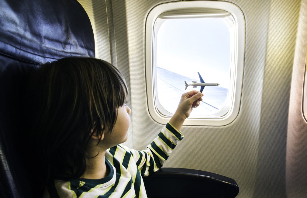 Child plays with toy plane